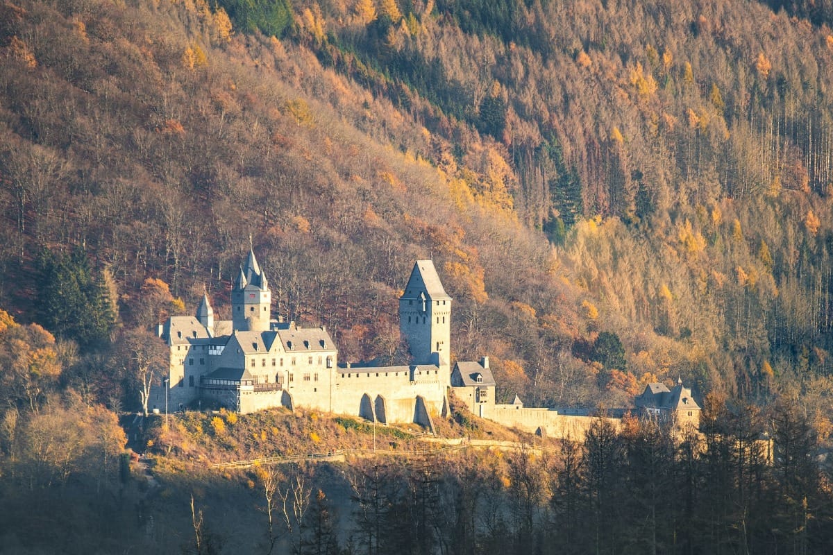 white and brown concrete building on top of hill